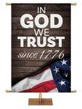 Patriotic Banner In God We Trust Since 1776 in white letters on dark barnwood background with flag with stars on the left