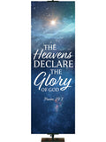 The Heavens Declare The Glory of God Psalm 19:1. Star-filled night sky with brightly shining star in the distance and white and light blue lettering