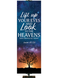 Lift Up Your Eyes and Look to The Heavens - Who Created All These? Isaiah 40:26. Star-filled sky with silhouette of tree in the distance at sunset and white and light blue lettering