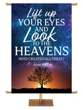 Lift Up Your Eyes and Look to The Heavens - Who Created All These? Isaiah 40:26. Star-filled sky with silhouette of tree in the distance at sunset and white and light blue lettering