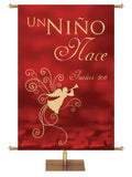 A Child is Born. Isaiah 9:6. Spanish Christmas Banner A Child is Born in Crimson or Spruce with Angel in the look of foil.