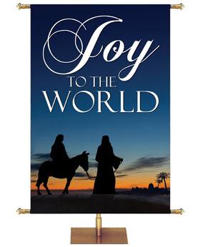 Joy To The World Banner For Christmas with Joseph Walking Leading Mary on The Donkey Towards Bethlehem At Sunset