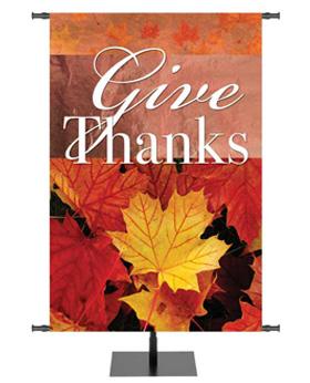 Give Thanks Banner for Fall and Thanksgiving with various color Autumn leaves under the words and screened image behind the words