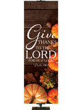Give Thanks to the Lord Psalm 136:1 Autumn Heartland Design D Left rustic dark brown horizontal wood planks with multicolor pumpkins and autumn decor on right side