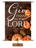 Give Thanks to the Lord Psalm 136:1 Autumn Heartland Design D Left rustic dark brown horizontal wood planks with multicolor pumpkins and autumn decor on right side