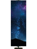 Star-filled night sky with silhouette of distant mountain