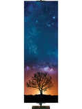 Star-filled sky with silhouette of tree in the distance at sunset