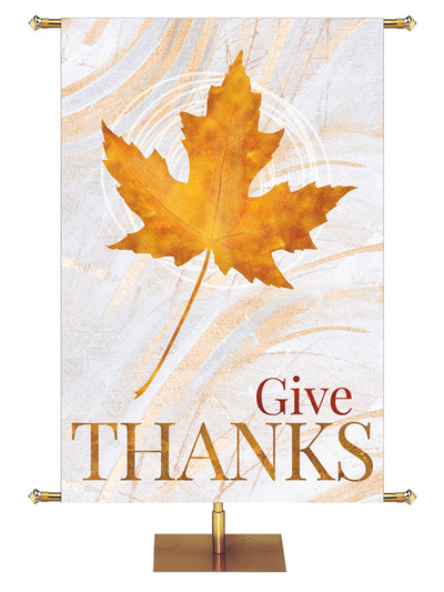 Fall Banner for Church Give Thanks in Gold Letters with Single Gold Maple leaf on background of hues of bronze and copper