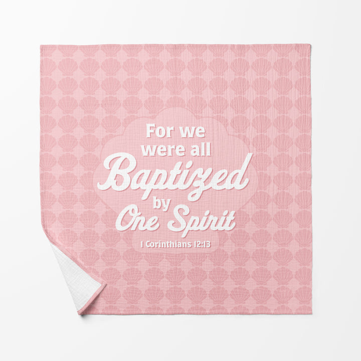 Baby Swaddle Faith Blanket with For We Were All Baptized by One Spirit 1 Corinthians 12:13 in White letters on Pink background with shell symbols 