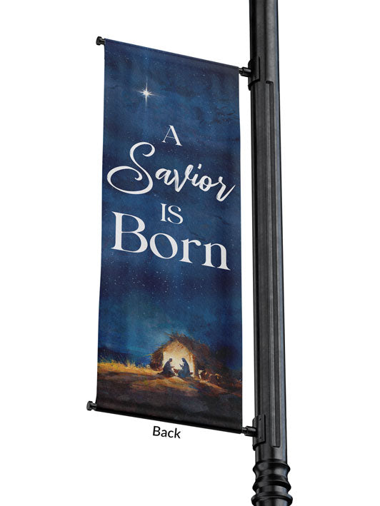 Outdoor Light Pole Banner A Savior is Born in White Letters on Night Sky background with the New Star and The Manger Scene