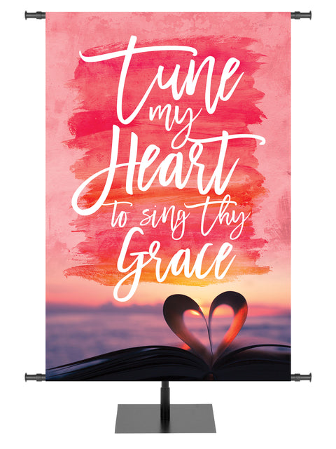 Church Banner with pastel heart and sunrise over ocean and verse Tune my Heart to sing Thy Grace