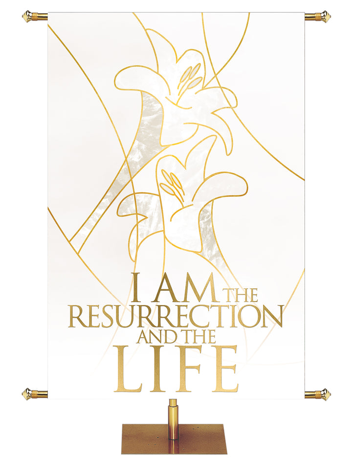 Easter Liturgy I Am The Resurrection on White Banner with two Easter Lily Blooms left above right outlined in gold in wide banner format