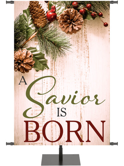 Church Banner for Christmas A Savior Is Born on rustic wood with pine cones and holly